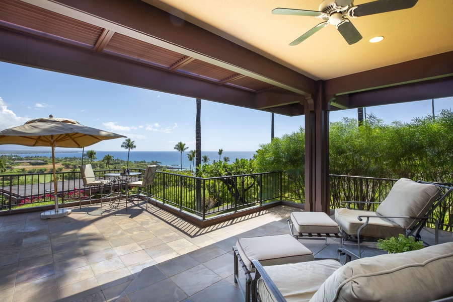 Private lanai lounge with unobstructed ocean views and plush seating, ideal for serene afternoons.
