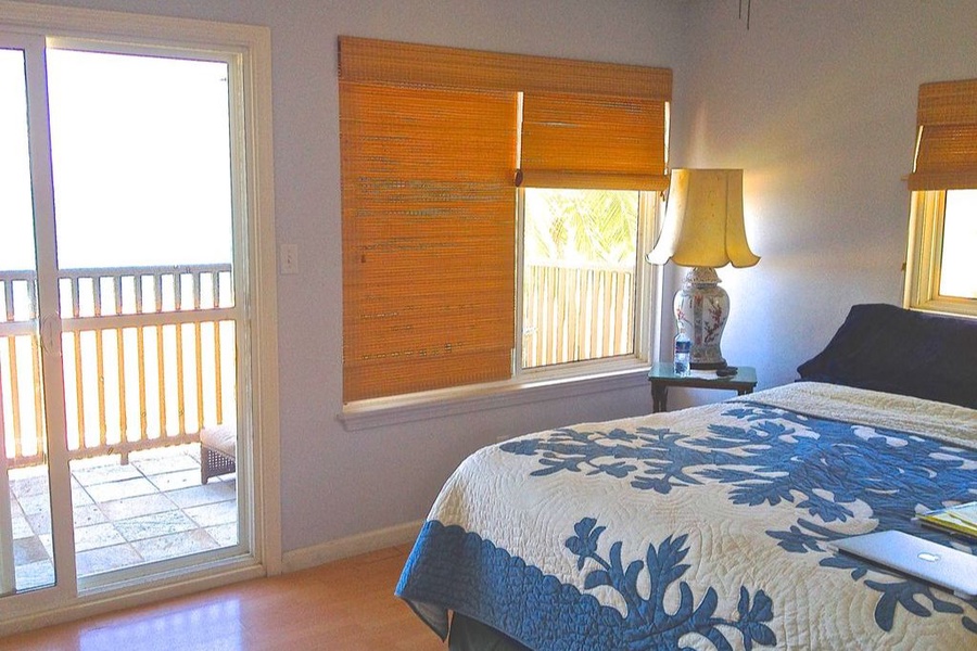Guest bedroom with a queen bed and access to private lanai.
