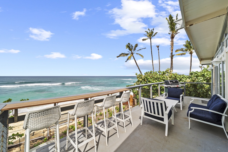 Headline oceanfront view from the upper deck—your front-row seat to Haleiwa’s rolling waves and golden sunrises.