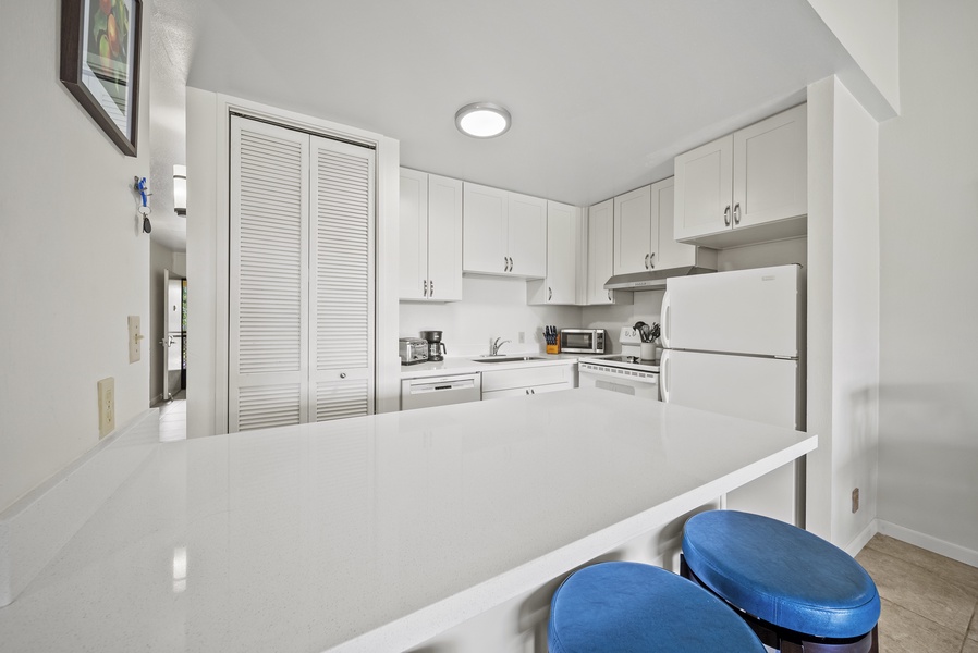 The kitchen offers ample counter spaces for a breezy meal prep.