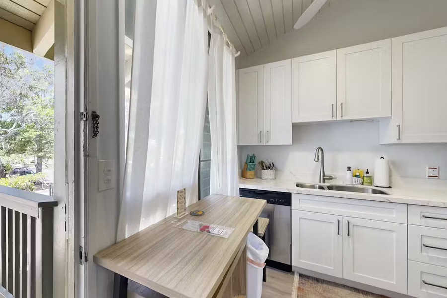 Breakfast counter beside sliding doors and soft curtains.