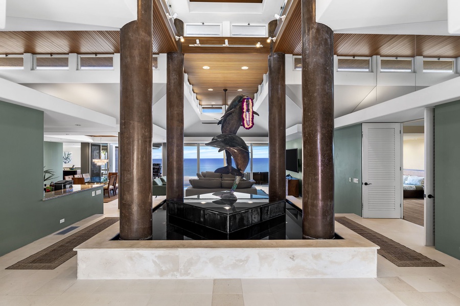 Step into a stunning foyer where modern elegance meets artistic flair, featuring soaring columns and sculptural centerpiece.