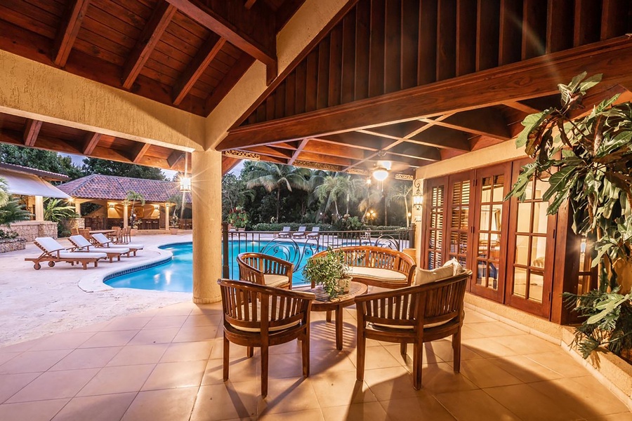 Gather in the guest house's patio with views of the pool.