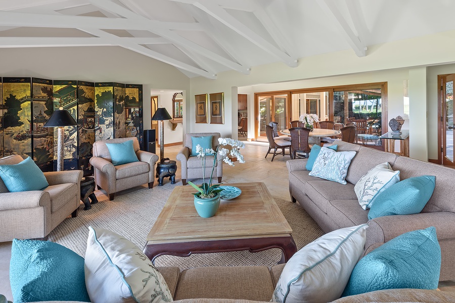 Formal living area with elegant furnishings and views of the lush garden.