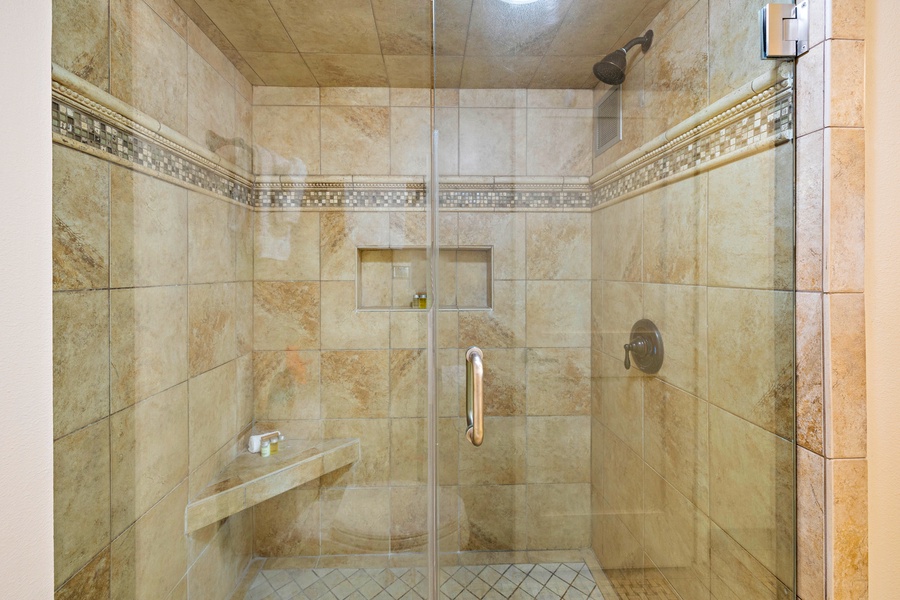 Spacious walk-in shower with elegant tile details.