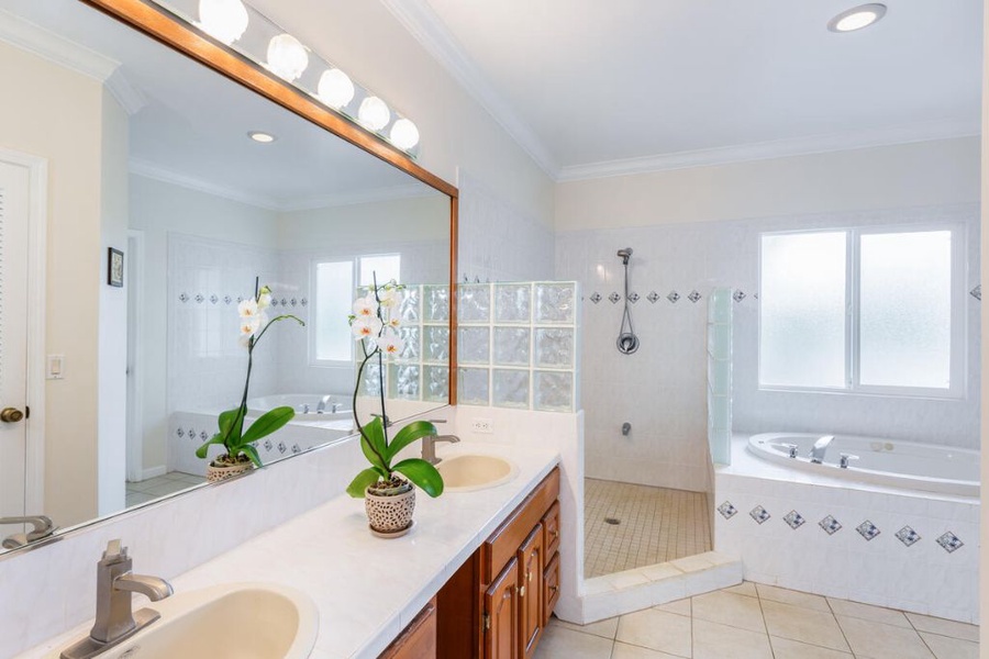 The ensuite bathroom features a soaking tub, dual sink and a separate shower