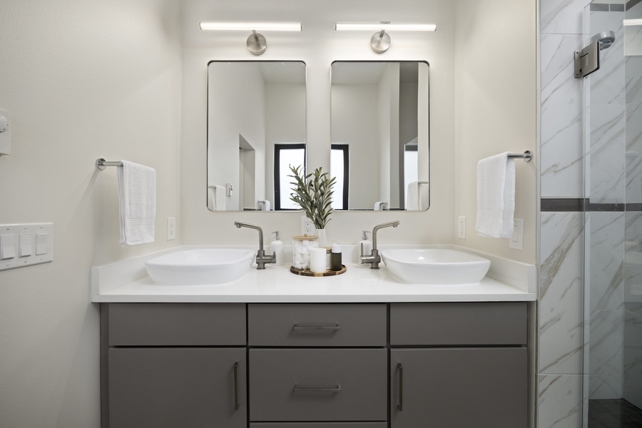 Double-vanity bathroom offering ample space and soft lighting — perfect for couples or shared use.