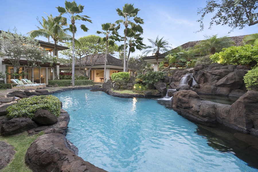 Tropical lagoon style pool with natural rocks and cascading waterfalls.