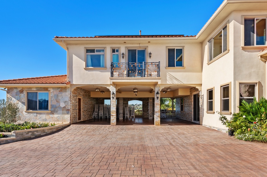 A sweeping paver motor court and stately columns create a grand sense of arrival while offering ample space for guests.