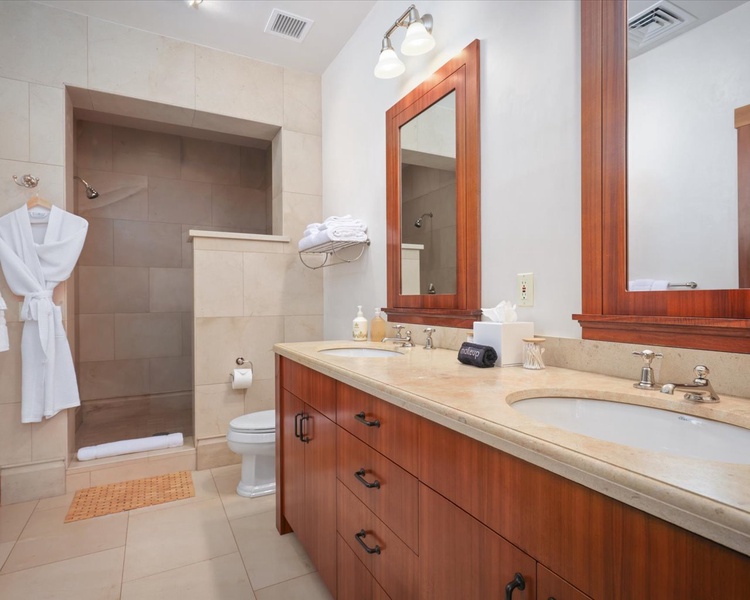 En suite bathroom with dual vanities, walk-in shower & outdoor shower