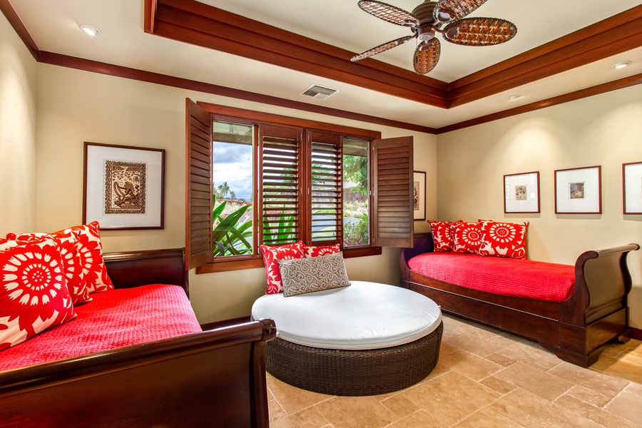 Bright and cheerful guest suite with two twin beds, ideal for friends or kids, featuring tropical garden views.