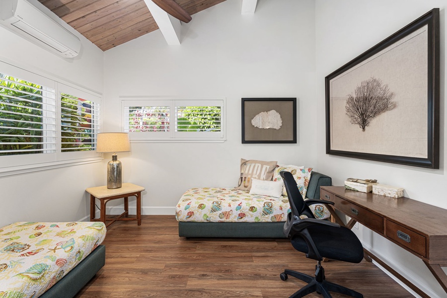 A bright, airy bedroom with a dedicated workspace for quiet moments and easy mornings.