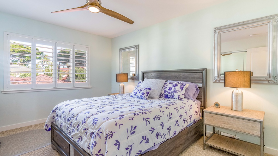 The second guest bedroom is brightly decorated with soft patterns and linens.