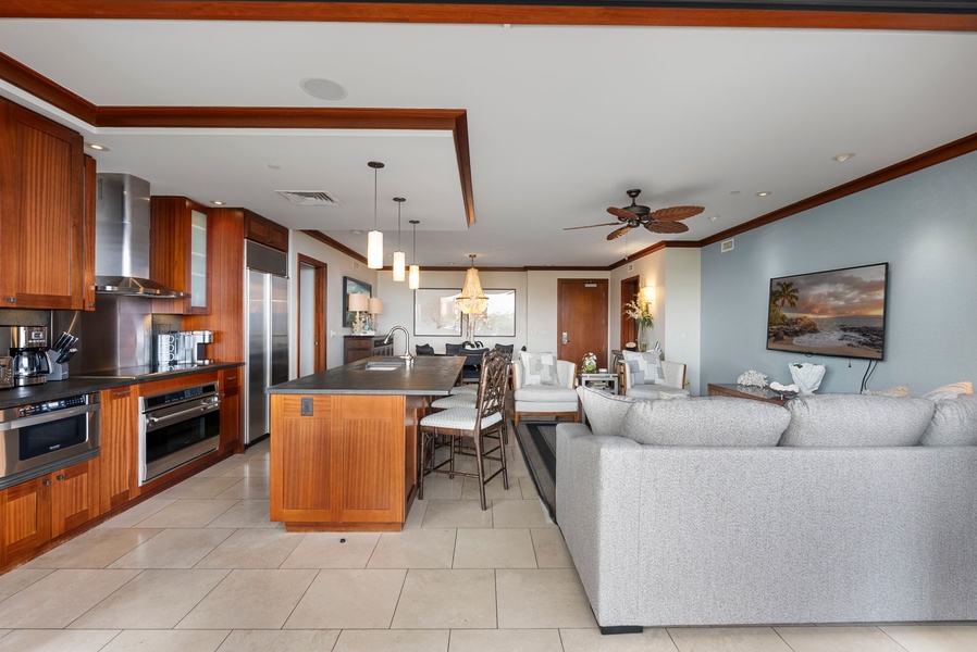 Unwind in your open-plan living space where rich wood finishes meet modern luxury, perfect for cooking together and relaxing.