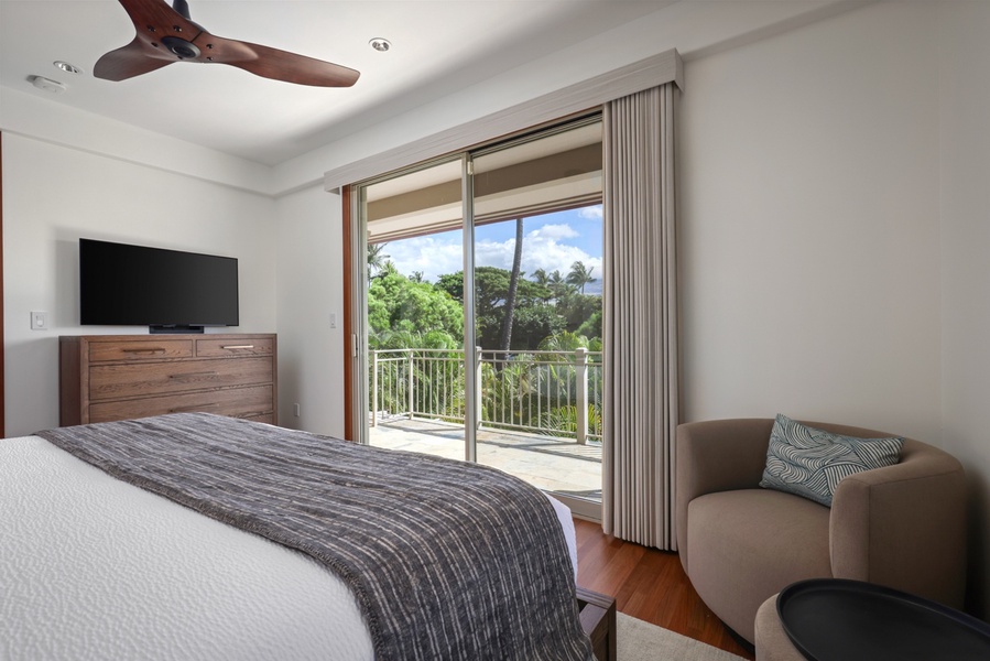 Reverse view of bedroom showcasing wall-mounted Smart TV and lanai access.