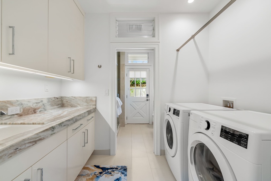 Conveniently located laundry nook offering full washer and dryer for guest use.