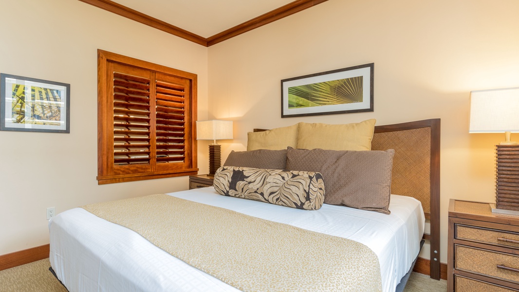 Warm wood tones and tasteful decor in the primary guest bedroom.