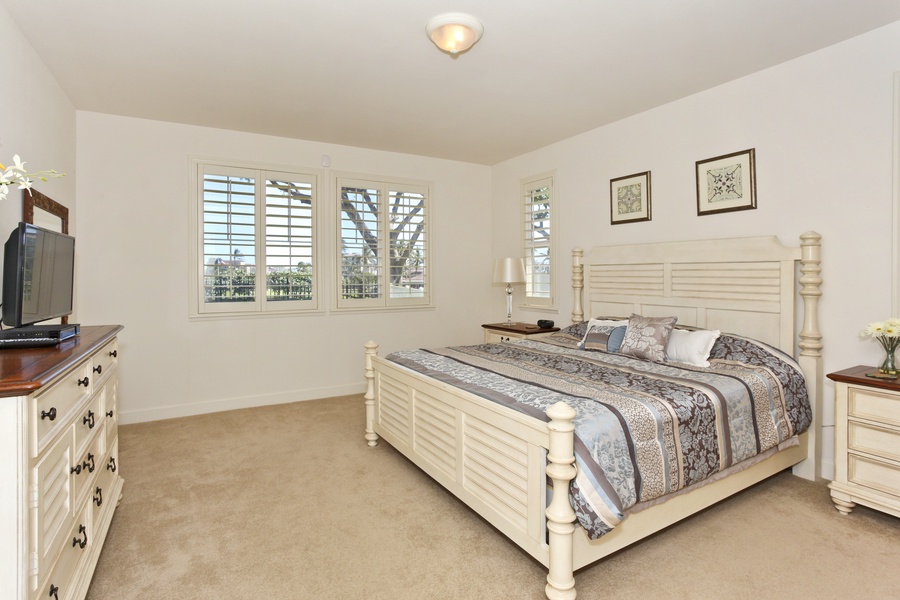 The spacious primary guest bedroom with coastal furnishings.