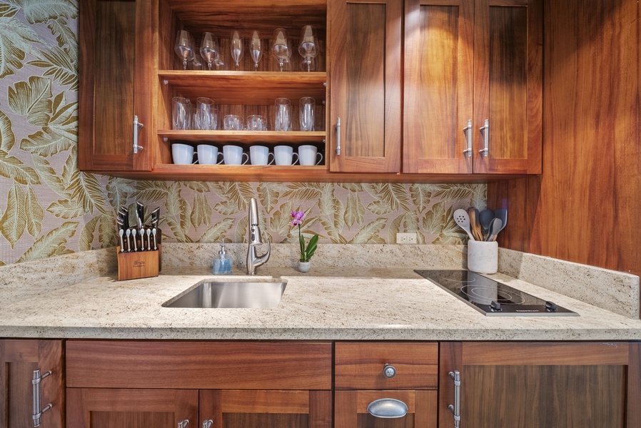 Island-inspired kitchenette with tropical backsplash and custom cabinetry, perfect for casual cooking.