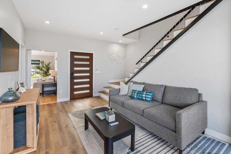 Two living areas downstairs with modern staircase leading to the bedrooms.