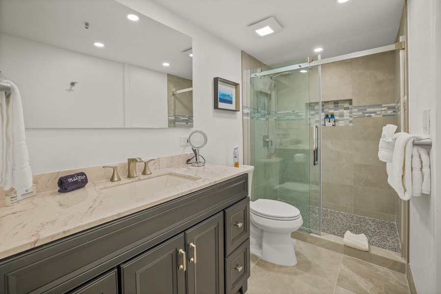 Sleek bathroom at Kaanapali Shores 213 with a glass walk-in shower and modern vanity.