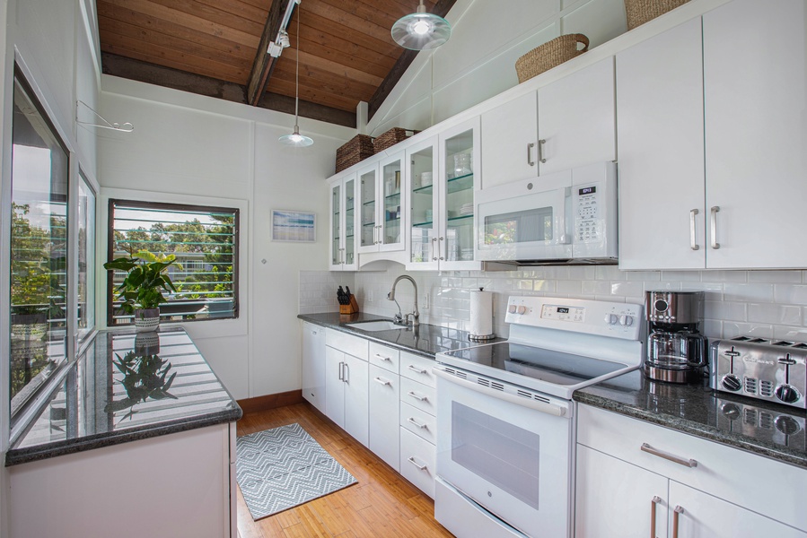 Prepare island-style meals in the fully remodeled kitchen with sleek cabinetry and modern appliances.