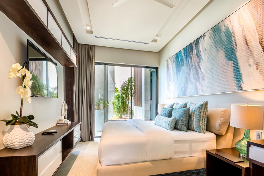 Rest in this elegant guest bedroom, complete with stylish furnishings and a private balcony.