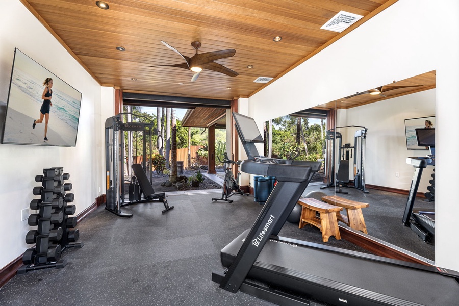 Your private fitness space features professional equipment with garden & pool views to energize your workout routine.