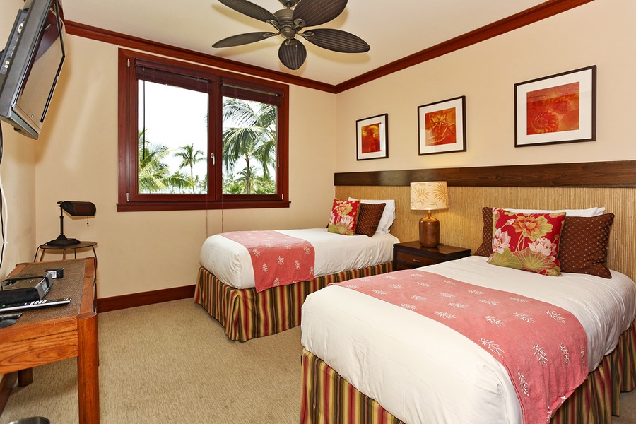 The third guest bedroom with twin beds and colorful framed art.