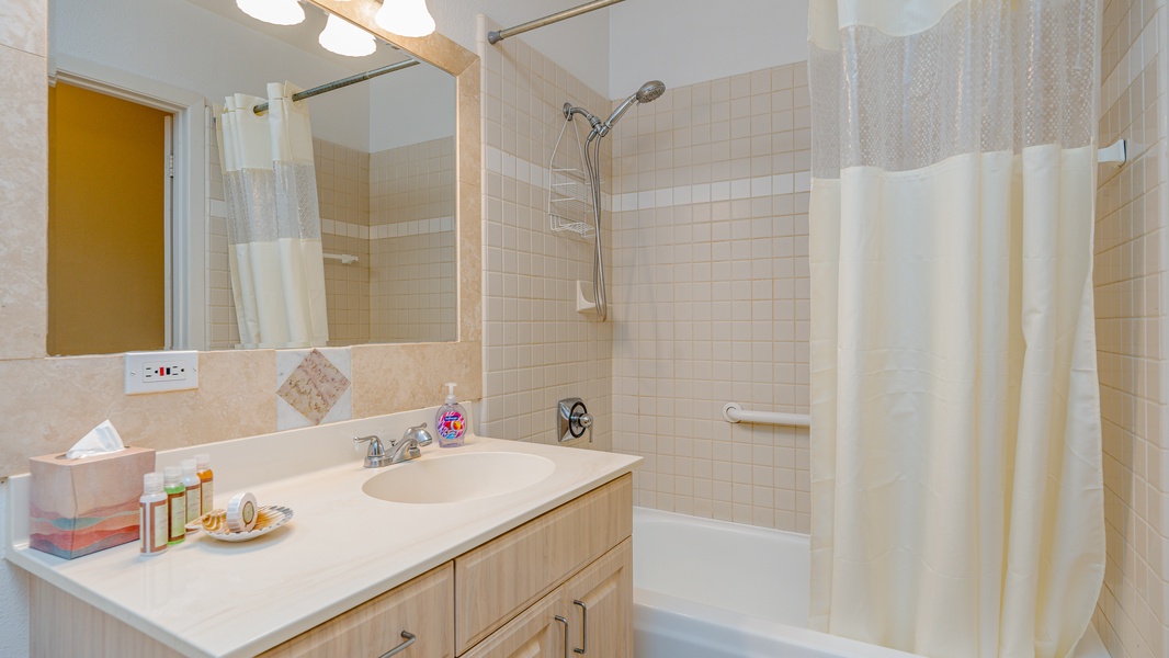 The second guest bathroom provides plenty of storage and large vanity.