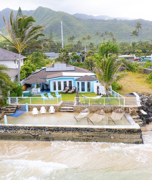 Stunning oceanfront property nestled between tropical mountains and pristine beach, featuring private beachfront access and island living at its finest.