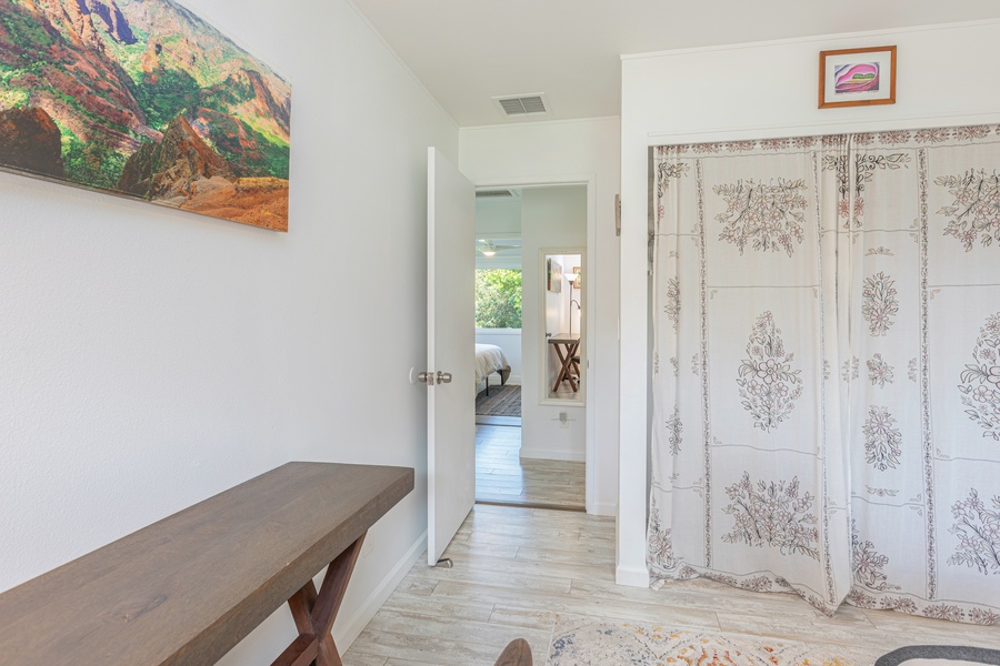 Hallway view with linen storage and access to full upstairs bathroom.