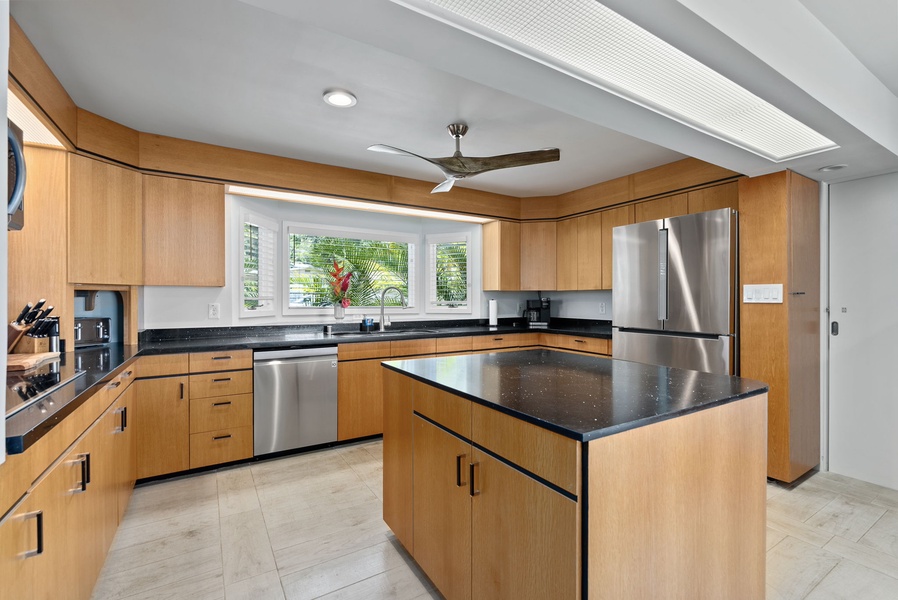 Top tier appliances completes the kitchen featuring sleek modern design.