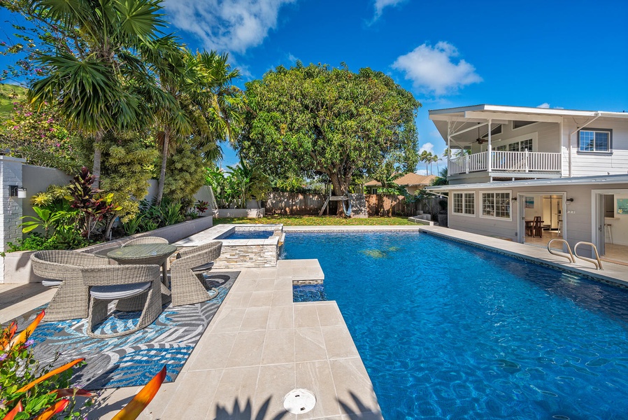 Lush backyard with large pool deck and pool give you all the feels of having your own private mini hotel!  (Note: Upper pool area is apart of the pool and NOT a spa)