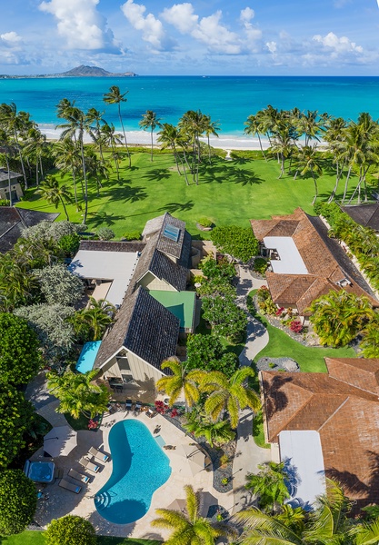 Aerial view of the stunning estate, showcasing its luxurious layout and lush surroundings.