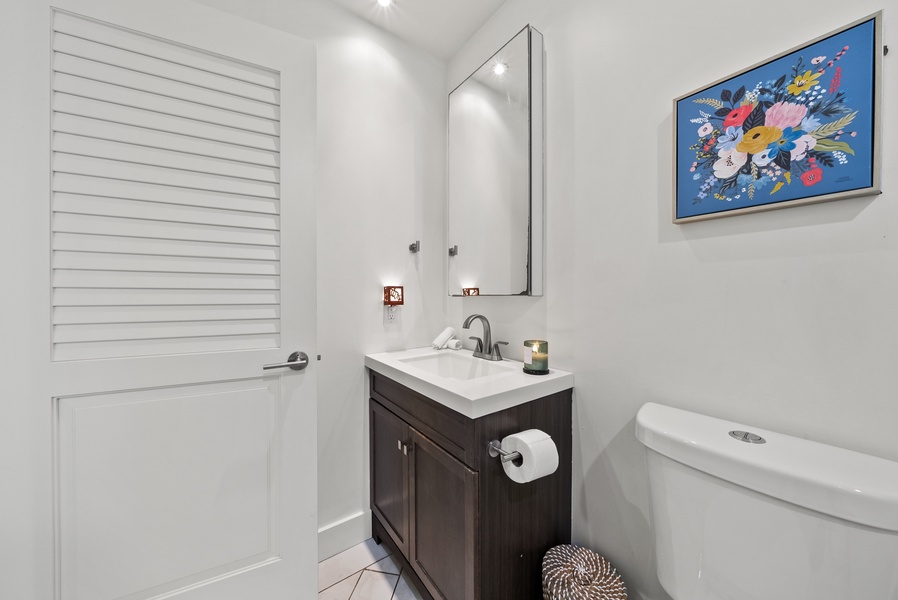 Modern bathroom with a sleek vanity and bright lighting.