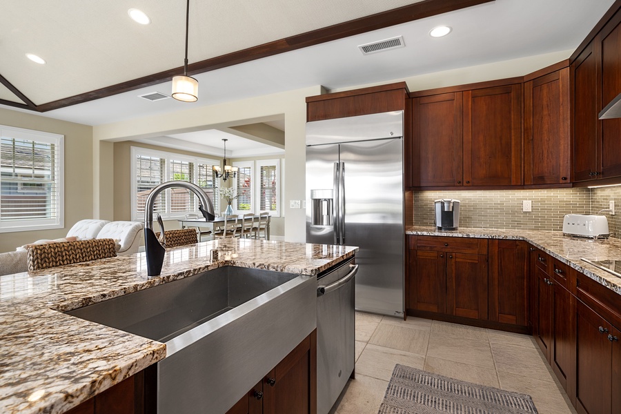 glorious chef kitchen is fully-equipped for your dining needs with a lineup of brand new, stainless steel appliances and stunning granite slab countertops.