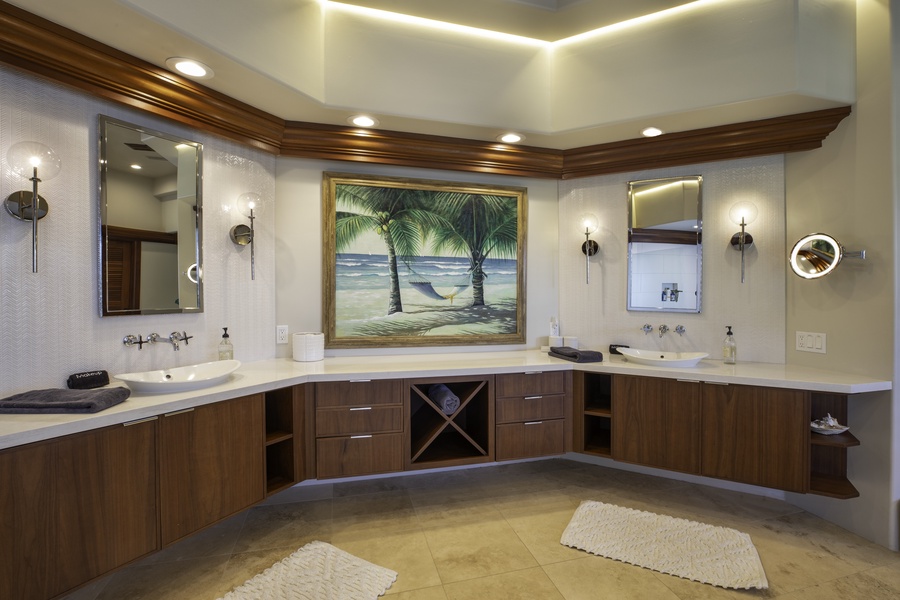 Unwind in your luxurious master bathroom with dual vanities, elegant tropical artwork, and sophisticated lighting that creates the perfect spa-like atmosphere.