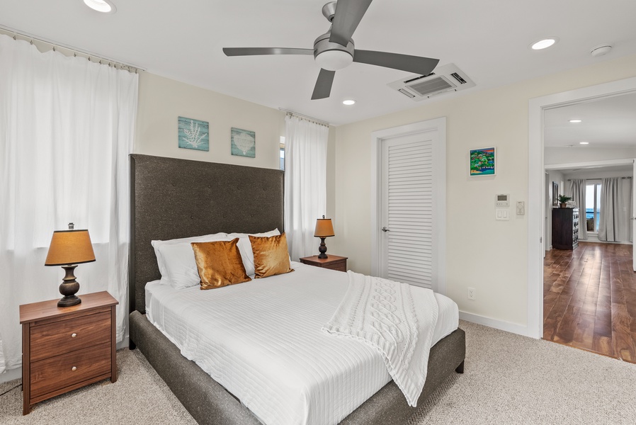 The guest bedroom in the upper level with a queen bed.