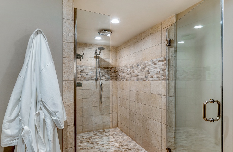 This luxurious walk-in shower offers a relaxing retreat with modern tile design and a spacious layout. Perfect for unwinding after a day in the sun.