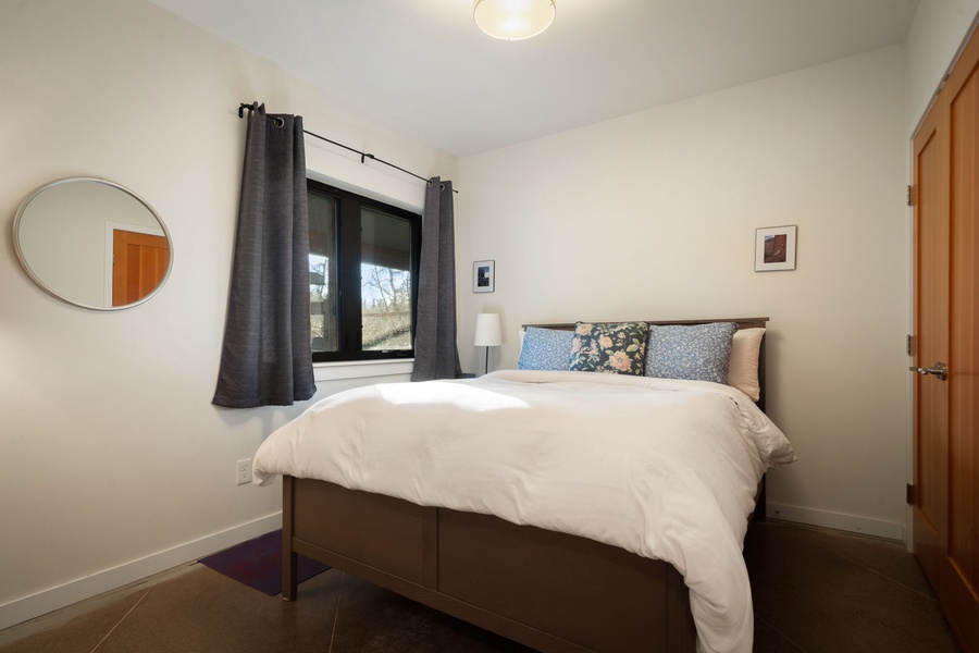 Sink into crisp white linens in your peaceful retreat, where natural light and thoughtful touches create the perfect sanctuary for restful nights.