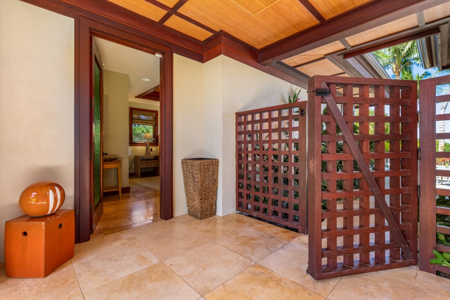 Peaceful garden walkway entrance with tropical charm.