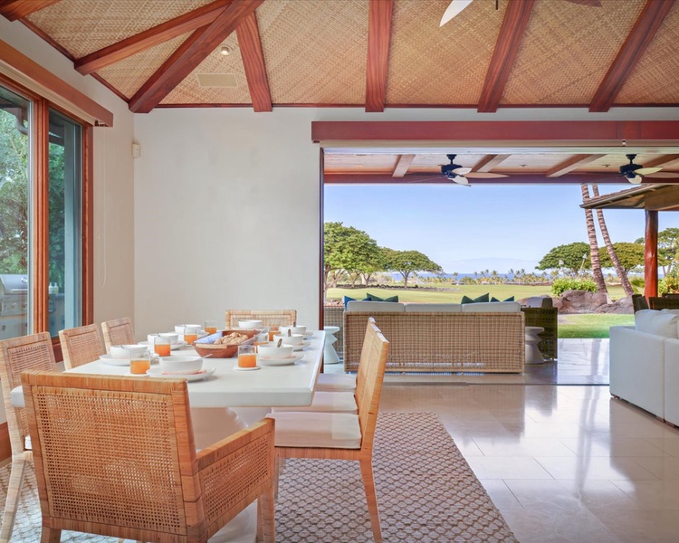 Charming dining for eight with views toward the Pacific Ocean & Maui