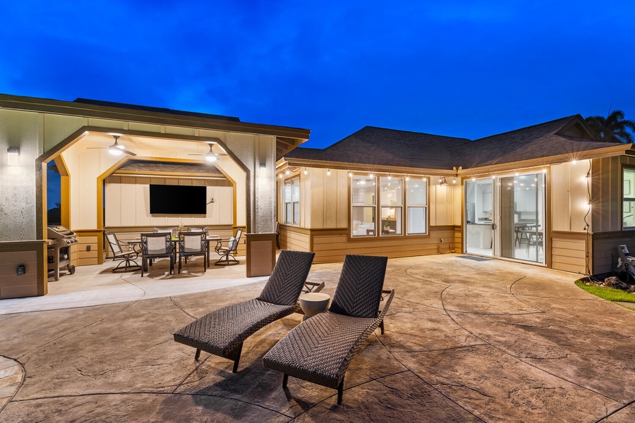 Spacious lanai with loungers and indoor-outdoor flow.