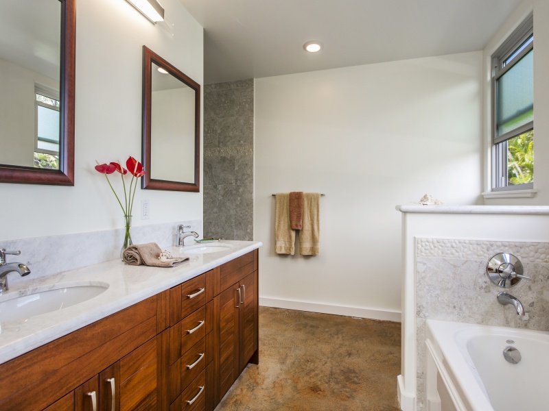 First-floor primary bath with tub and walk-in shower.