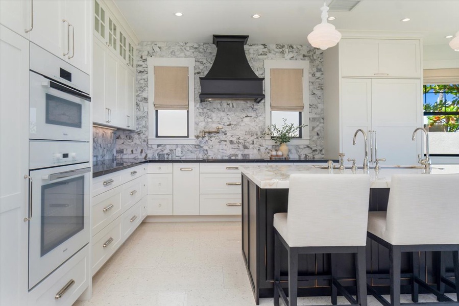 Gourmet kitchen with dual islands, premium appliances, and breezy ocean views.