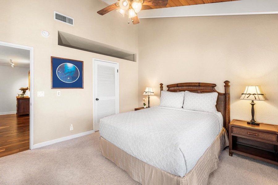 Another view of the guest bedroom with coastal-inspired décor and ample light.