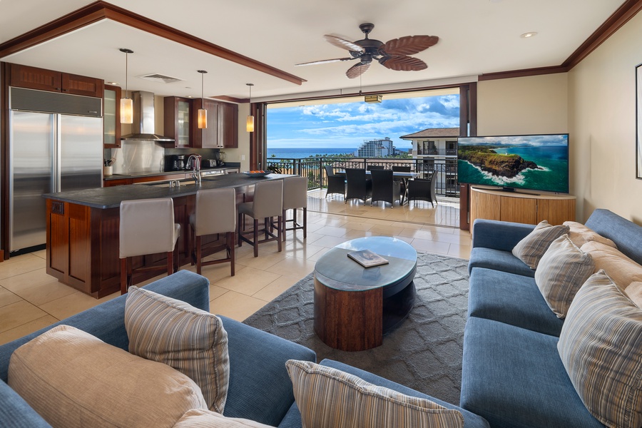 The living area with TV and sectional, looking to the lanai and beyond.