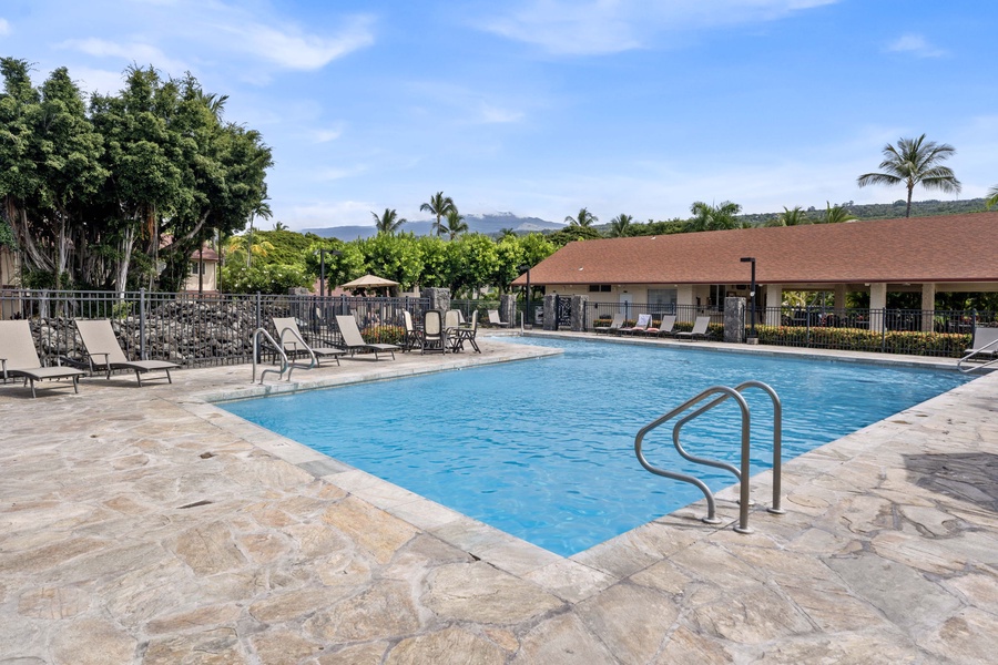 Lounge in style beside the shimmering pool on comfortable chaise lounges — the perfect spot for sunbathing and serene relaxation.