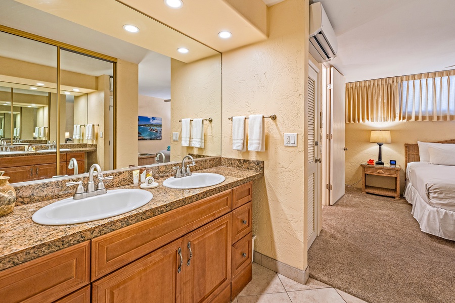 The bathroom features a double vanity with plenty of counter space, making it easy to get ready for the day while offering a touch of luxury.